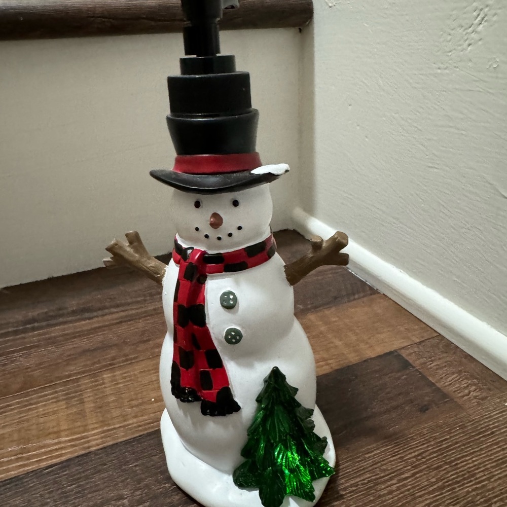 Snowman lotion dispenser the Christmas tree lights up